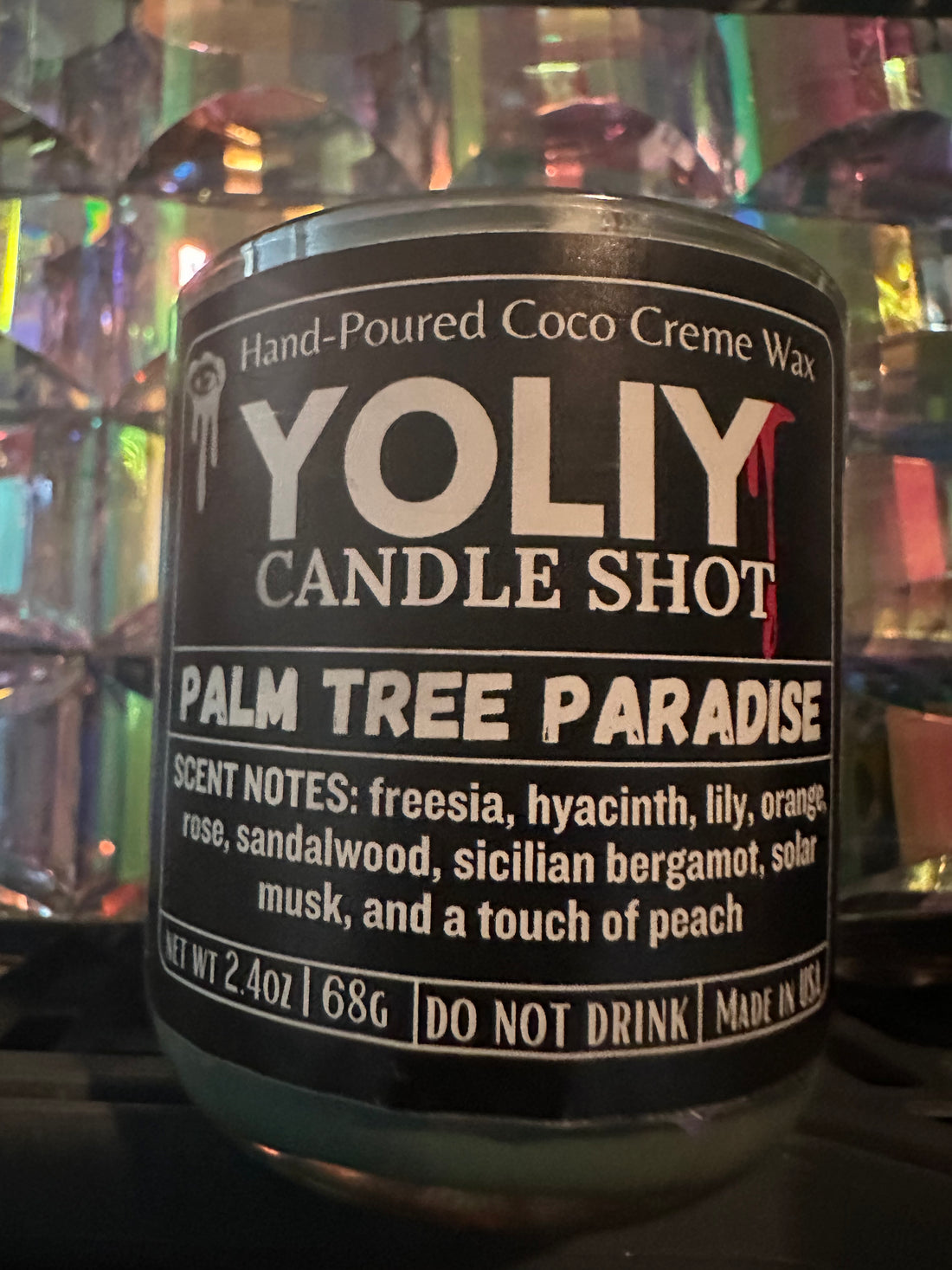 YOLIY Palm Tree Paradise Candle Shot comes in a 2.5 oz iridescent sage color vessel.This scent blends soft florals like freesia, hyacinth, rose, and lily with sparkling Sicilian bergamot, sweet orange, and a playful touch of peach.